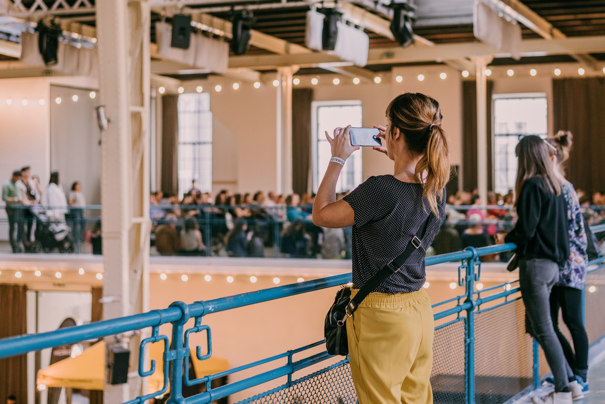 Event venue. Woman taking a picture of an event venue with her mobile phone.